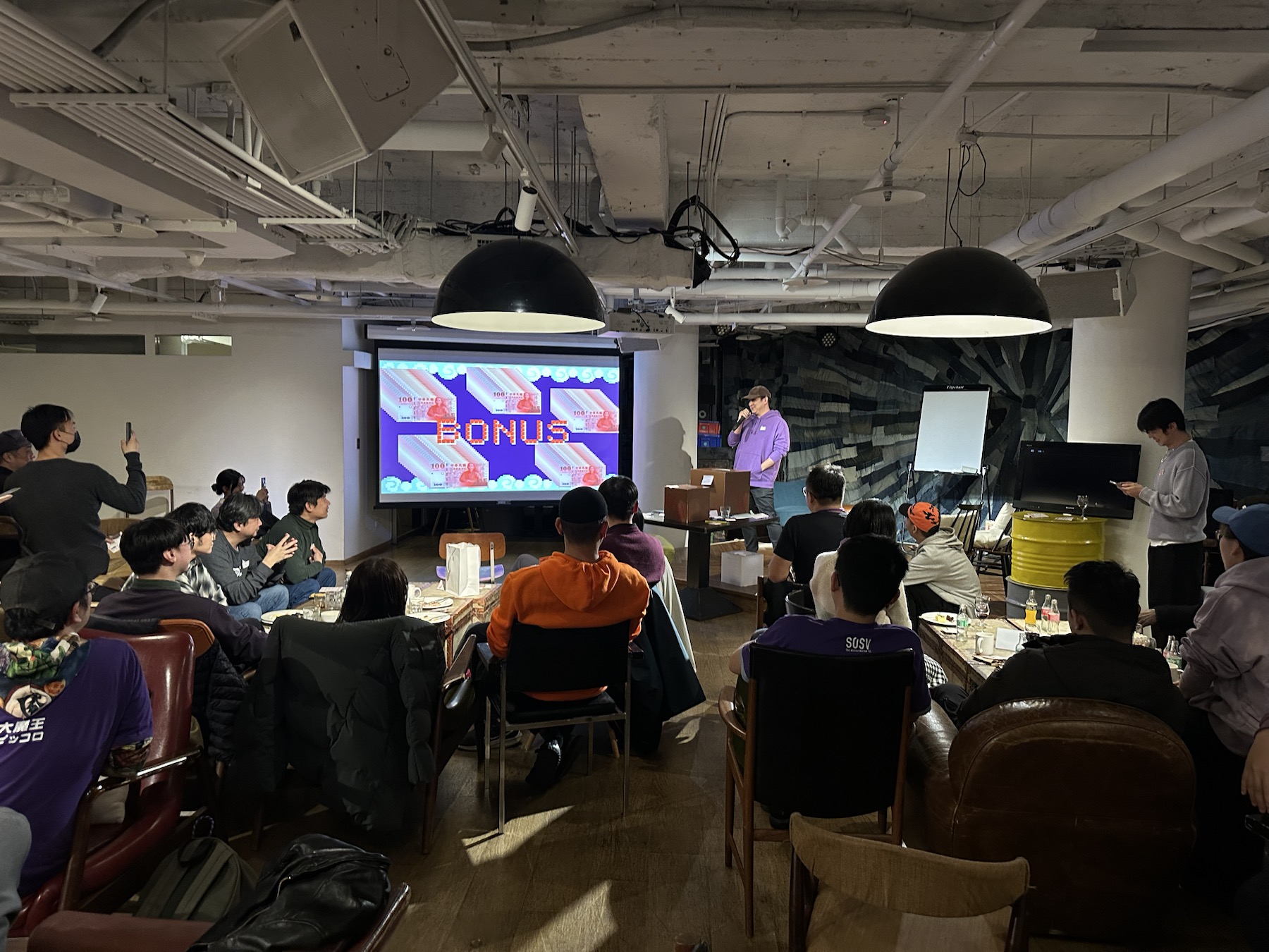 Founders watching a presentation during an 886 Studios community session